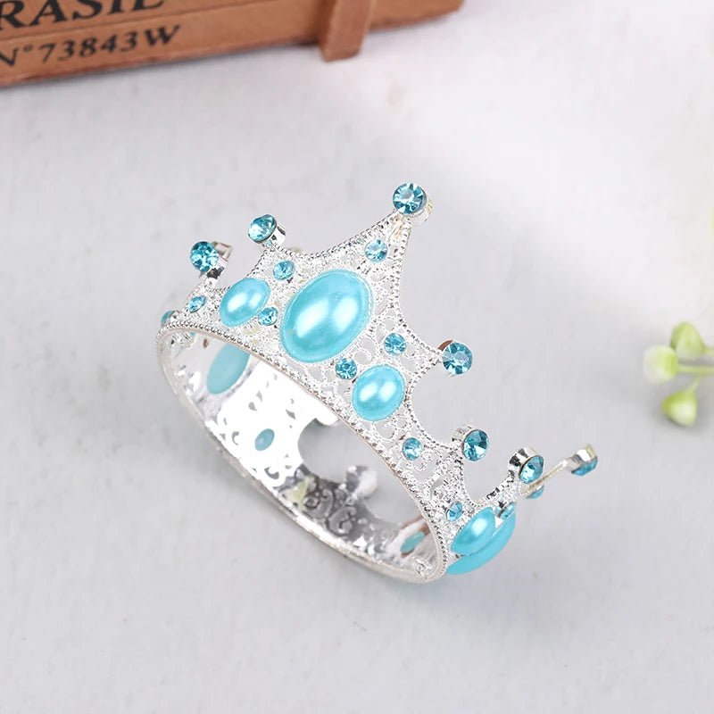 Silver tiara crown accessory with light blue gemstones and pearl accents