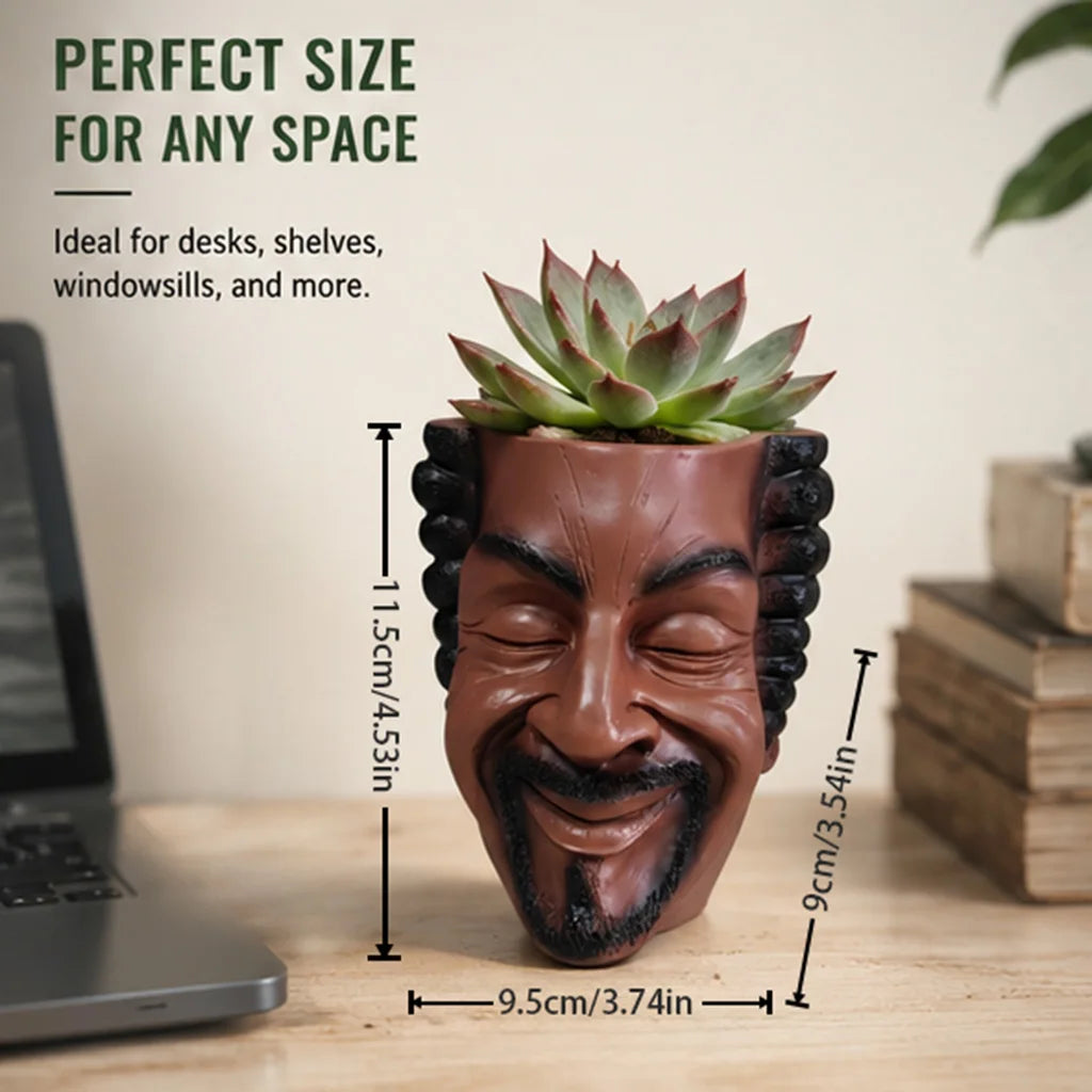 A terracotta-colored resin artistic face planter pot with textured features, shown on a wooden surface.