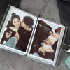A clear photo album containing two photos of a couple embracing and kissing.