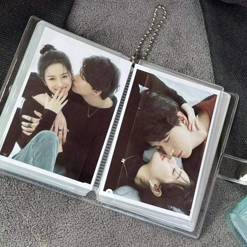 A clear photo album containing two photos of a couple embracing and kissing.