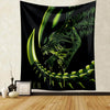 A dark tapestry wall hanging featuring a green alien predator head design.