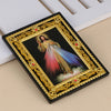 A framed religious icon depicting Jesus in a flowing garment with a radiant aura, set in an ornate gold frame.