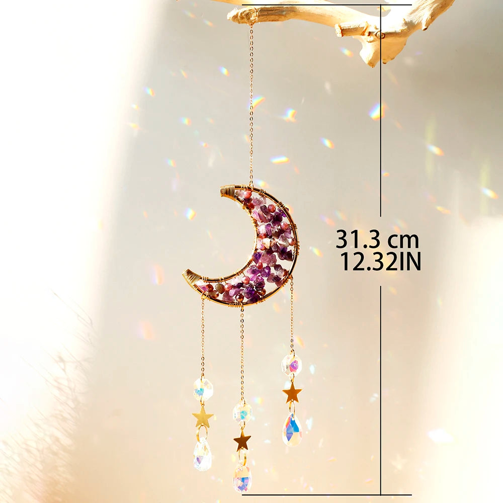 A hanging crystal dreamcatcher featuring a purple moon and dangling prism charms.