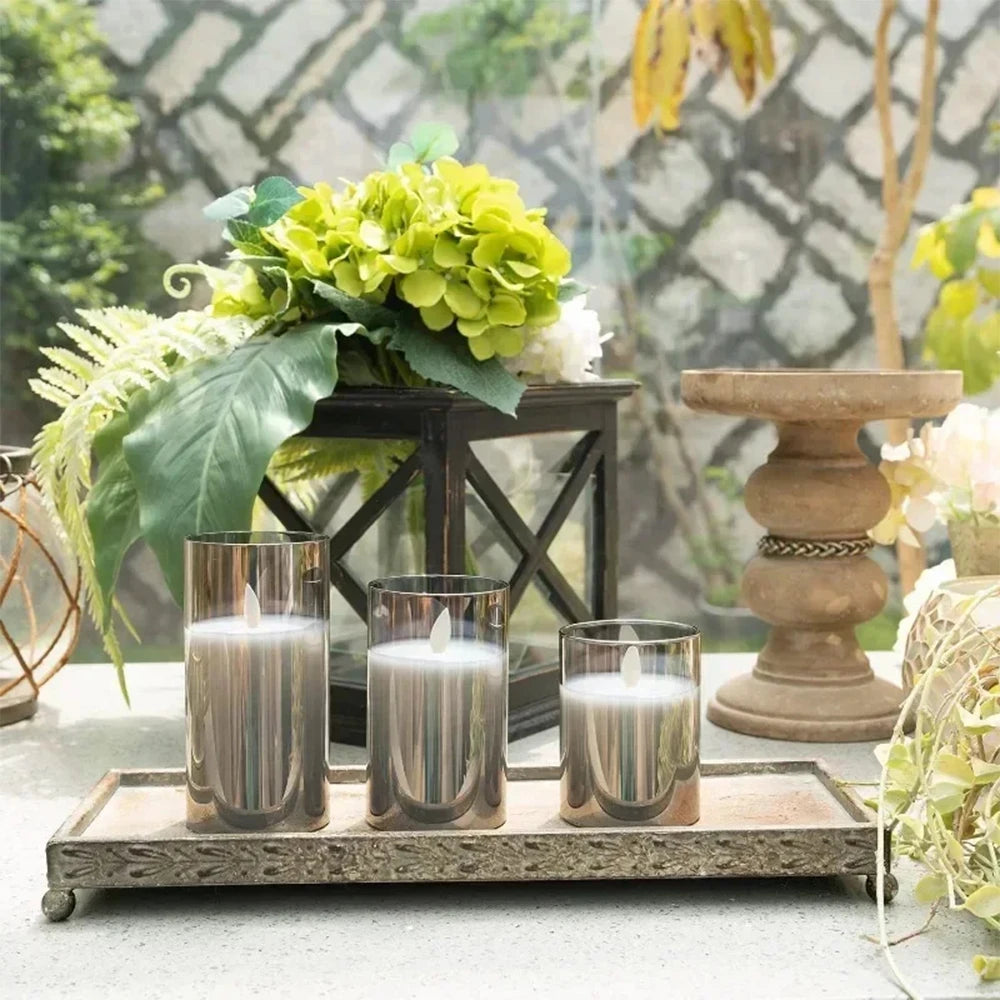 A set of LED flameless candles with flickering flame effect displayed on a wooden tray.