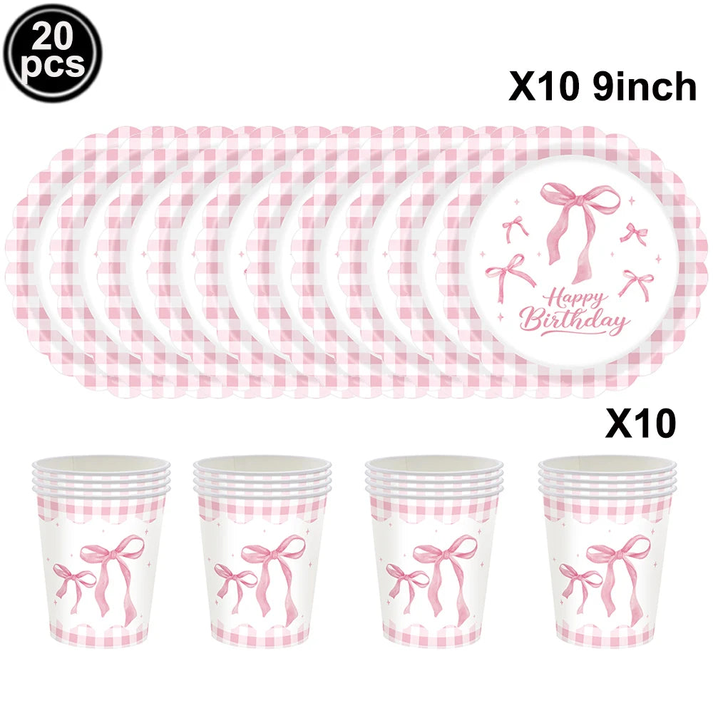 Pink checkered paper straws and cups with bow decorations for a birthday party