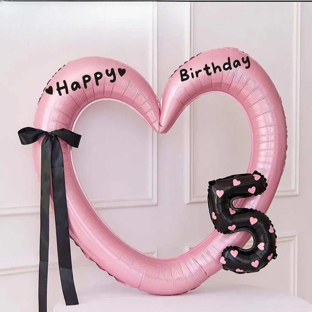 Pink heart-shaped balloon decoration with Happy and Birthday text