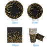 A set of black and gold disposable dinnerware including plates, cups, and napkins.