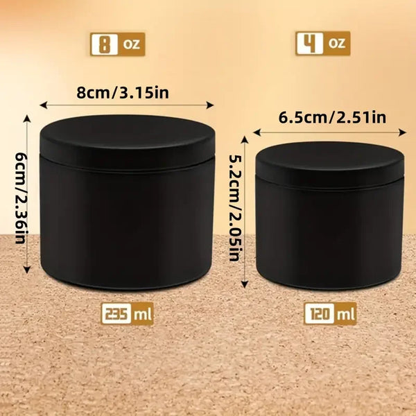 A set of two black metal candle tins with lids, one 8 oz and one 4 oz.