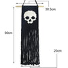 Tapis mural en macramé noir avec motif crâne et longues franges