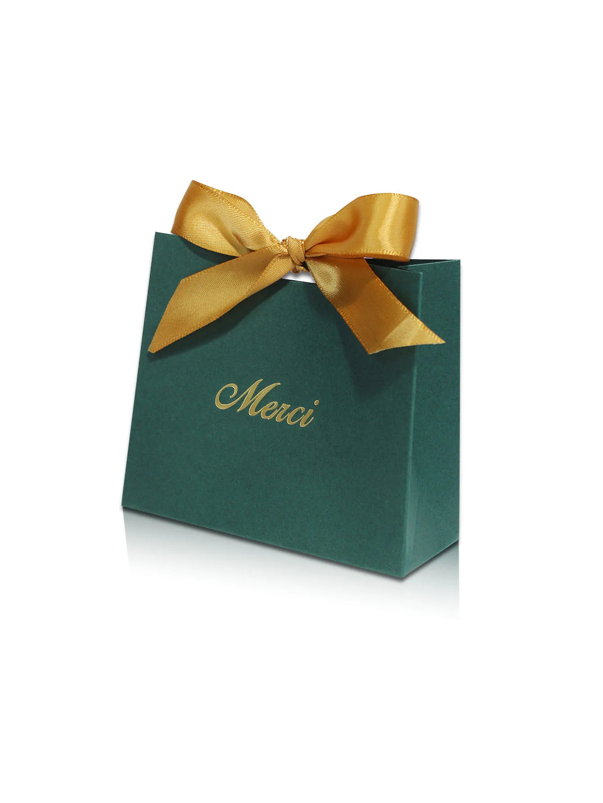 A dark green paperboard thank you gift bag tied with a gold ribbon, featuring the word Merci printed on it.