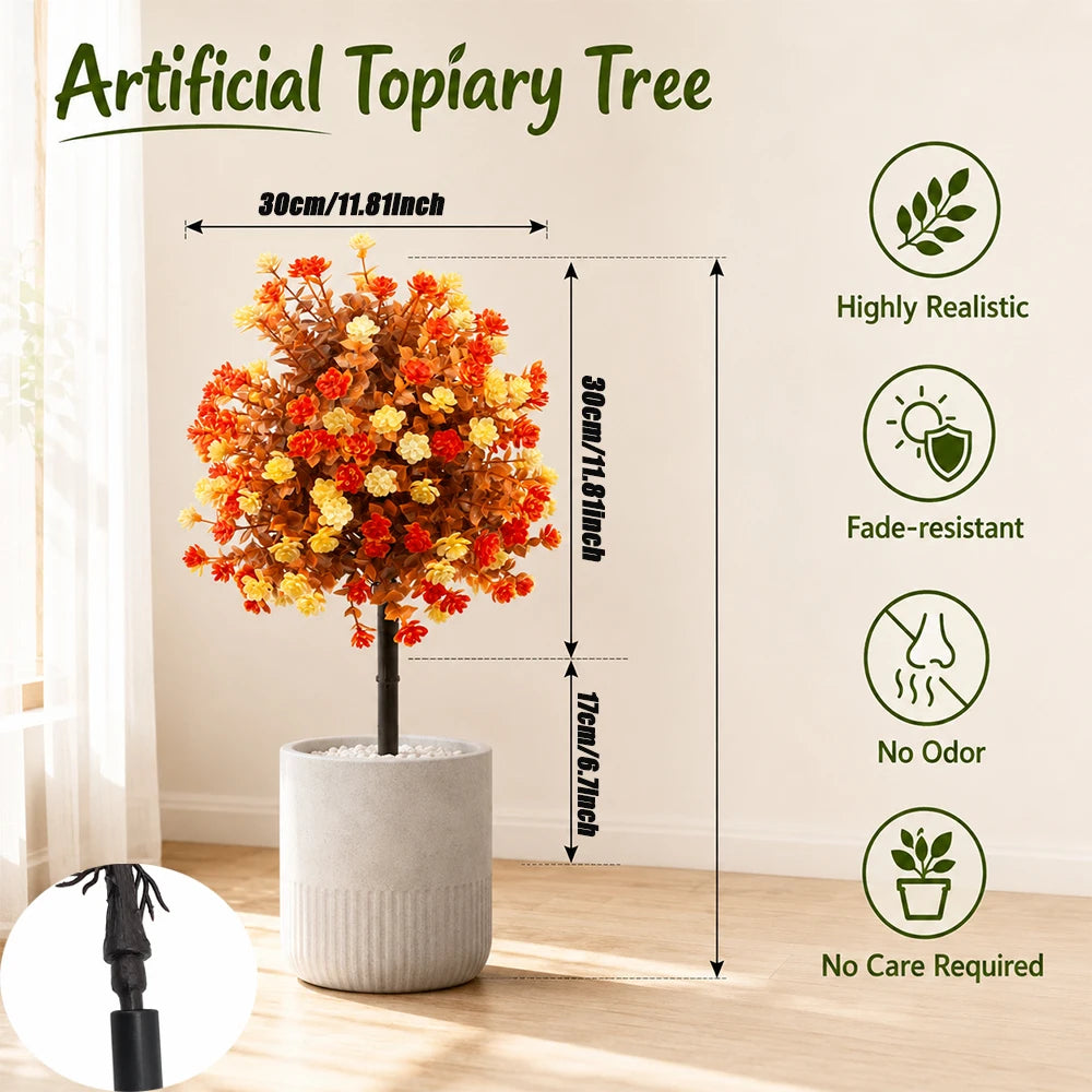 Árbol topiario artificial en maceta cilíndrica con follaje de colores estacionales, exhibido en interiores.