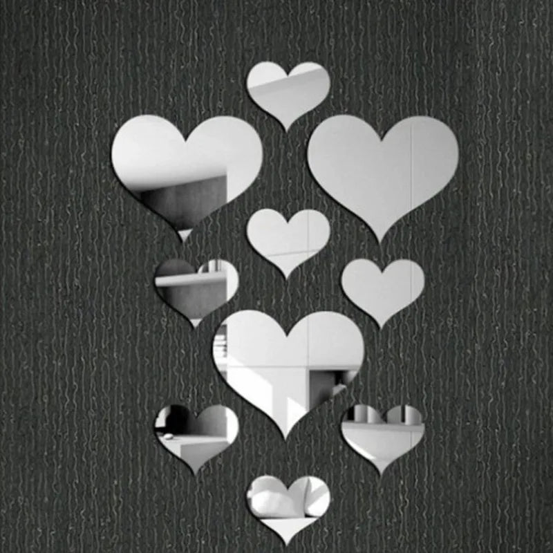 A collection of white 3D acrylic heart mirror wall stickers scattered against a dark background.