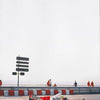A red and white Formula 1 race car is driving on a track, with a safety barrier in the foreground.