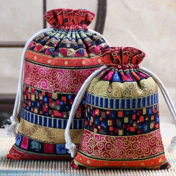 A set of vintage cotton drawstring gift pouches in various patterns and colors.