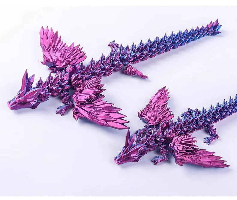 A pair of 3D printed articulated dragon fidget figurines in iridescent pink and blue colors.