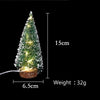 A small, illuminated LED Christmas tree with a snow effect, measuring 15cm tall and weighing 32g.