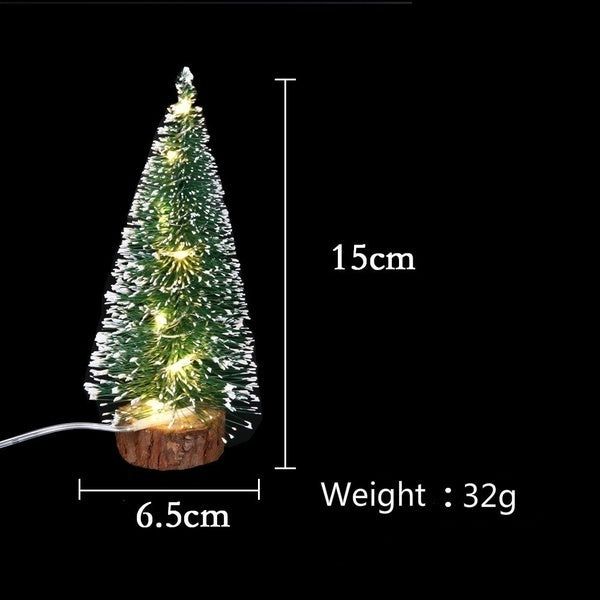 A small, illuminated LED Christmas tree with a snow effect, measuring 15cm tall and weighing 32g.