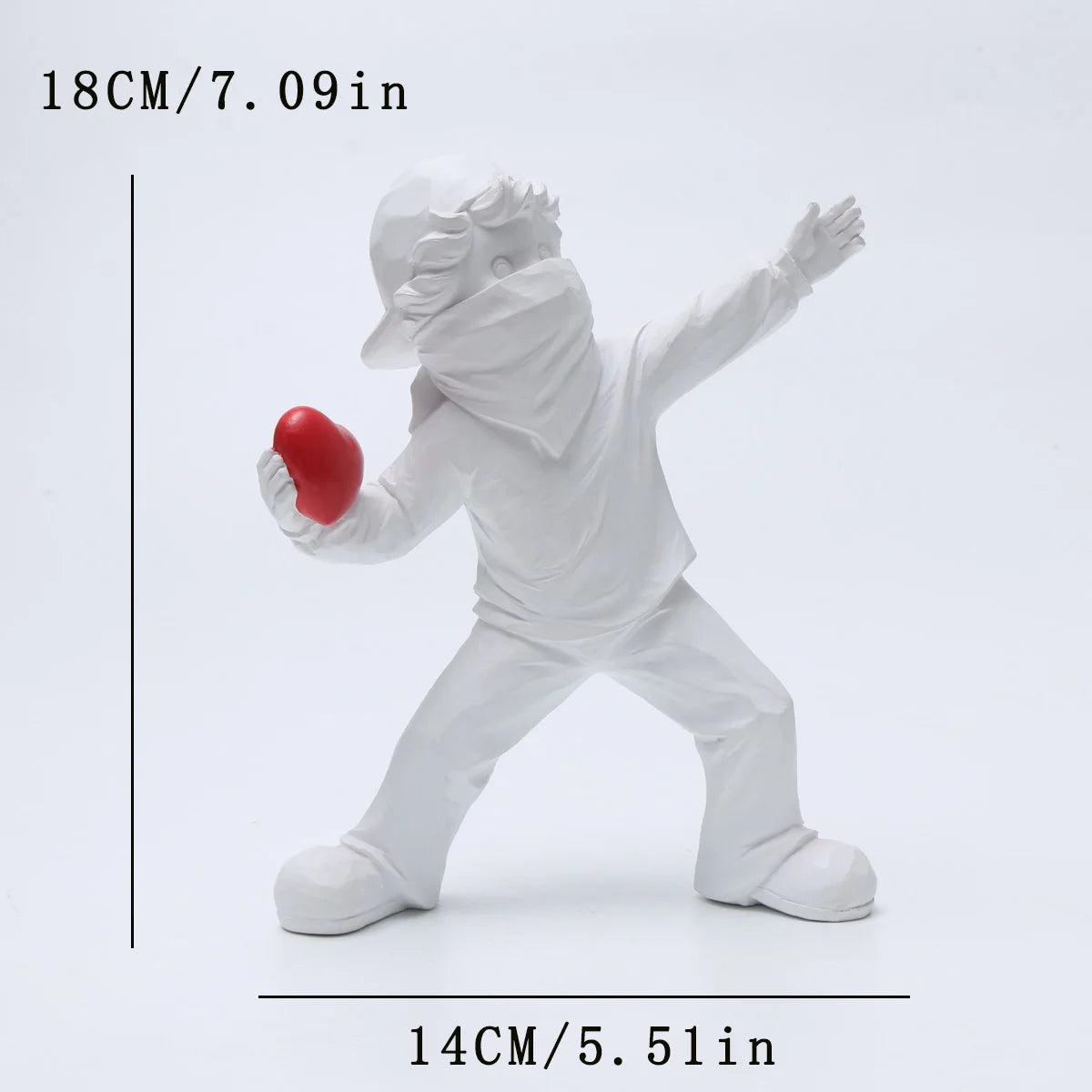 A white resin sculpture of a figure throwing a red ball, shown in a dynamic pose.