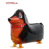 An inflatable cartoon farm animal foil balloon shaped like a brown dog with black and white markings.
