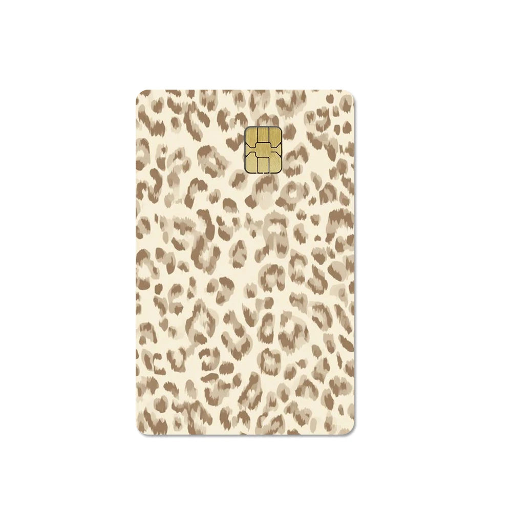 A beige card cover featuring a leopard print pattern and a gold-colored card slot.