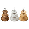 A set of three wooden tiered cupcake stands with detachable layers, showing different wood tones.