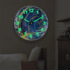 A minimalist round wall clock with glowing cyan hands displaying the time.