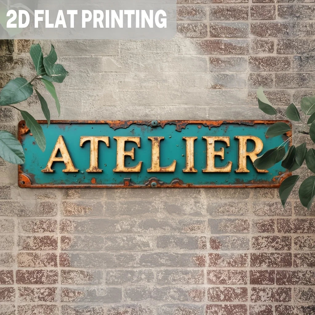 A vintage industrial metal wall sign with the word ATELIER in gold lettering mounted on a distressed turquoise metal plaque a