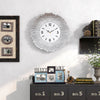 A modern 33cm silent wall clock with a white face and silver hands is displayed on a white wall.