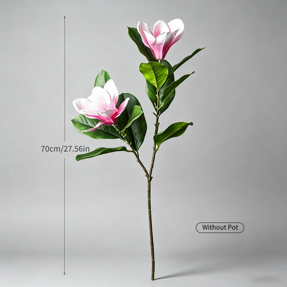A tall artificial magnolia tree with pink and white silk flowers on a slender stem.