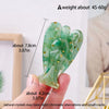 A hand holds a natural crystal guardian angel figurine, approximately 7.8 cm long and 4.2 cm wide.