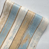 Rustic faux wood peel-and-stick wallpaper featuring vintage blue and white plank design.