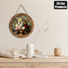 A round vintage floral wall art piece featuring roses and greenery mounted on a wooden frame.