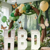 Large marquee light-up letters HBD for party decor decorated with green foliage and balloons