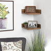 A set of wooden floating shelves displaying potted plants and a framed picture.