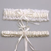 Ivory lace bowknot bridal garter set featuring delicate white lace and satin ribbons