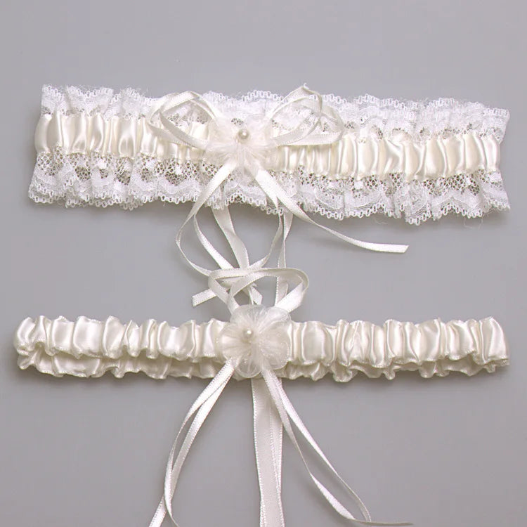 Ivory lace bowknot bridal garter set featuring delicate white lace and satin ribbons