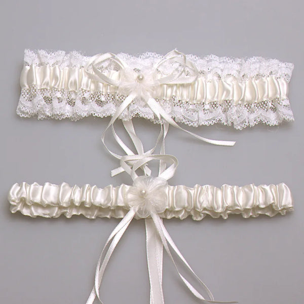 Ivory lace bowknot bridal garter set featuring delicate white lace and satin ribbons