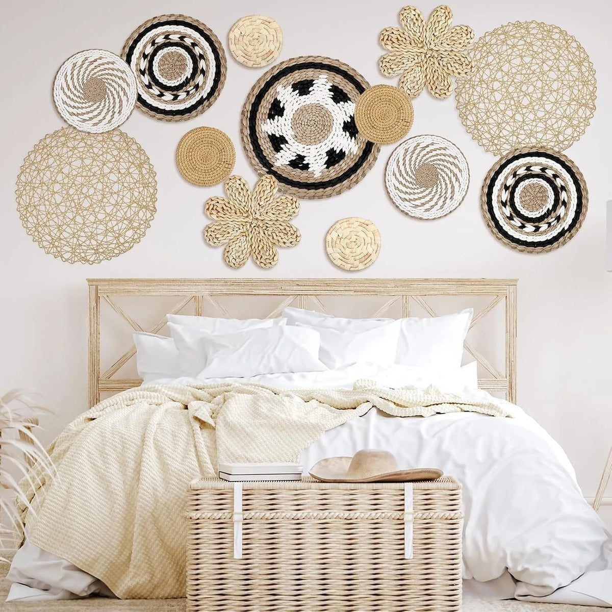A collection of woven straw wall hangings and tassels arranged above a bed.