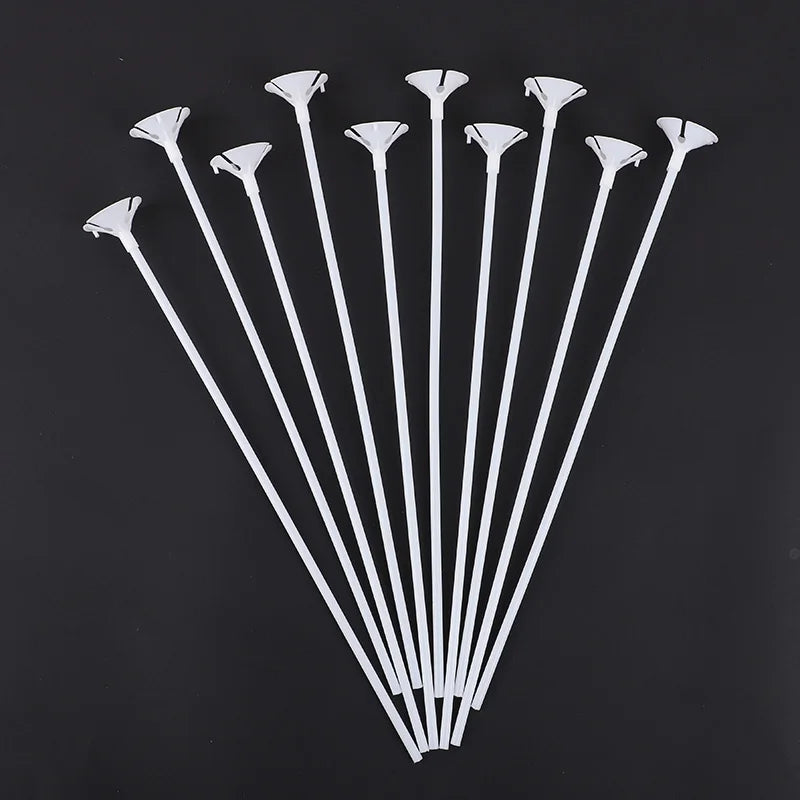 A collection of white macaron balloon sticks with holder cups arranged in a fan shape.