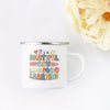 A white enamel mug with colorful text that reads It's a beautiful day for learning surrounded by floral elements.