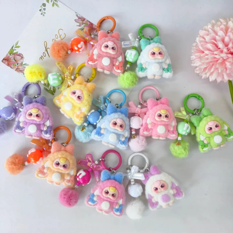 A collection of cute heart plush keychain charms in various colors like pink, yellow, green, and blue.