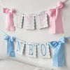 Pink and blue decorative birthday garland spelling out ONE and NEO made of lace