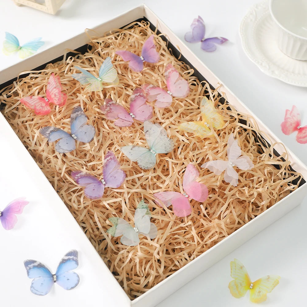 A box filled with various 3D embroidered butterfly patches in shades of pink, purple, and yellow.