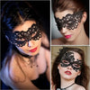 A woman wearing an elegant black lace masquerade mask for a costume party.
