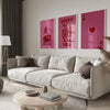 A modern living room features a light sofa and wooden table with framed retro letter art canvases on the wall.