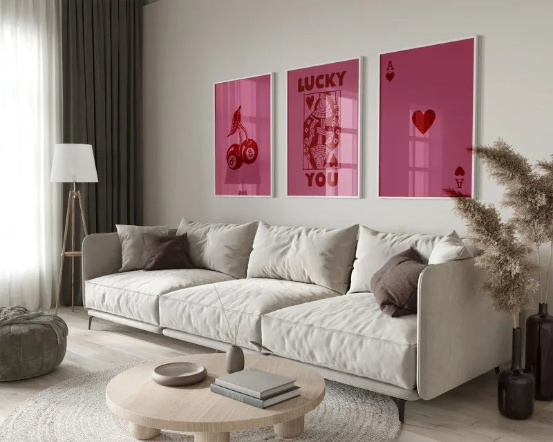 A modern living room features a light sofa and wooden table with framed retro letter art canvases on the wall.