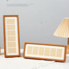 A wooden photo frame display stand with a six-grid design, featuring light wood and white borders.