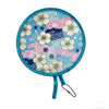 A round fabric fan featuring a blue and pink pattern with white floral designs.