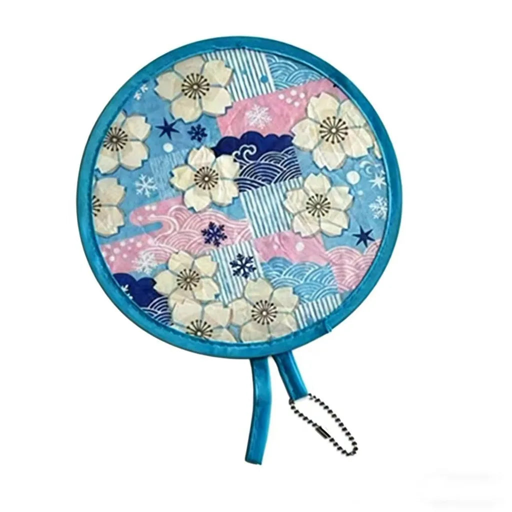 A round fabric fan featuring a blue and pink pattern with white floral designs.
