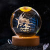 A spherical crystal ball with a laser engraved image of a leaping rabbit and the text Capricorn.